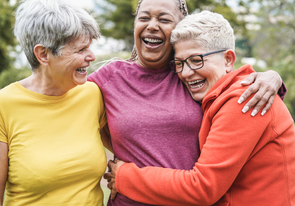 Group of seniors laughing together during a fitness activity at Heritage Senior Communities